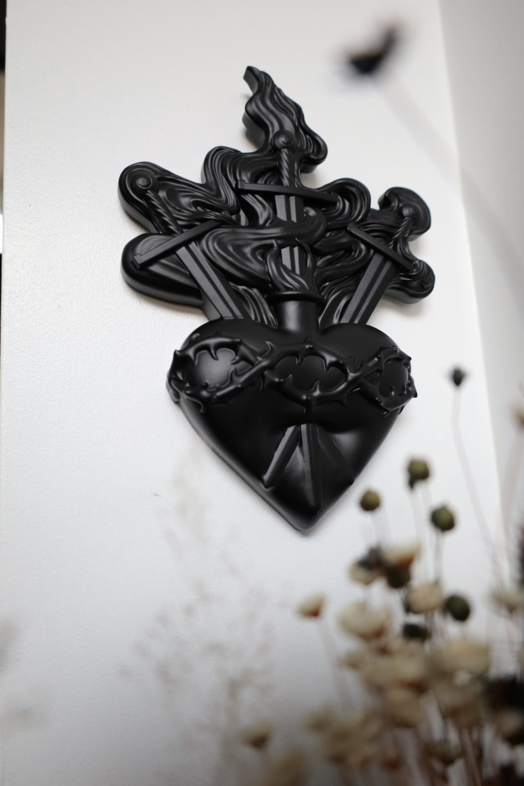 Black heart with swords and flames design 