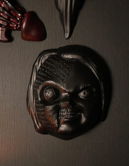 Close up of Chucky wall hanging from the movie Childs Play with the spell. 