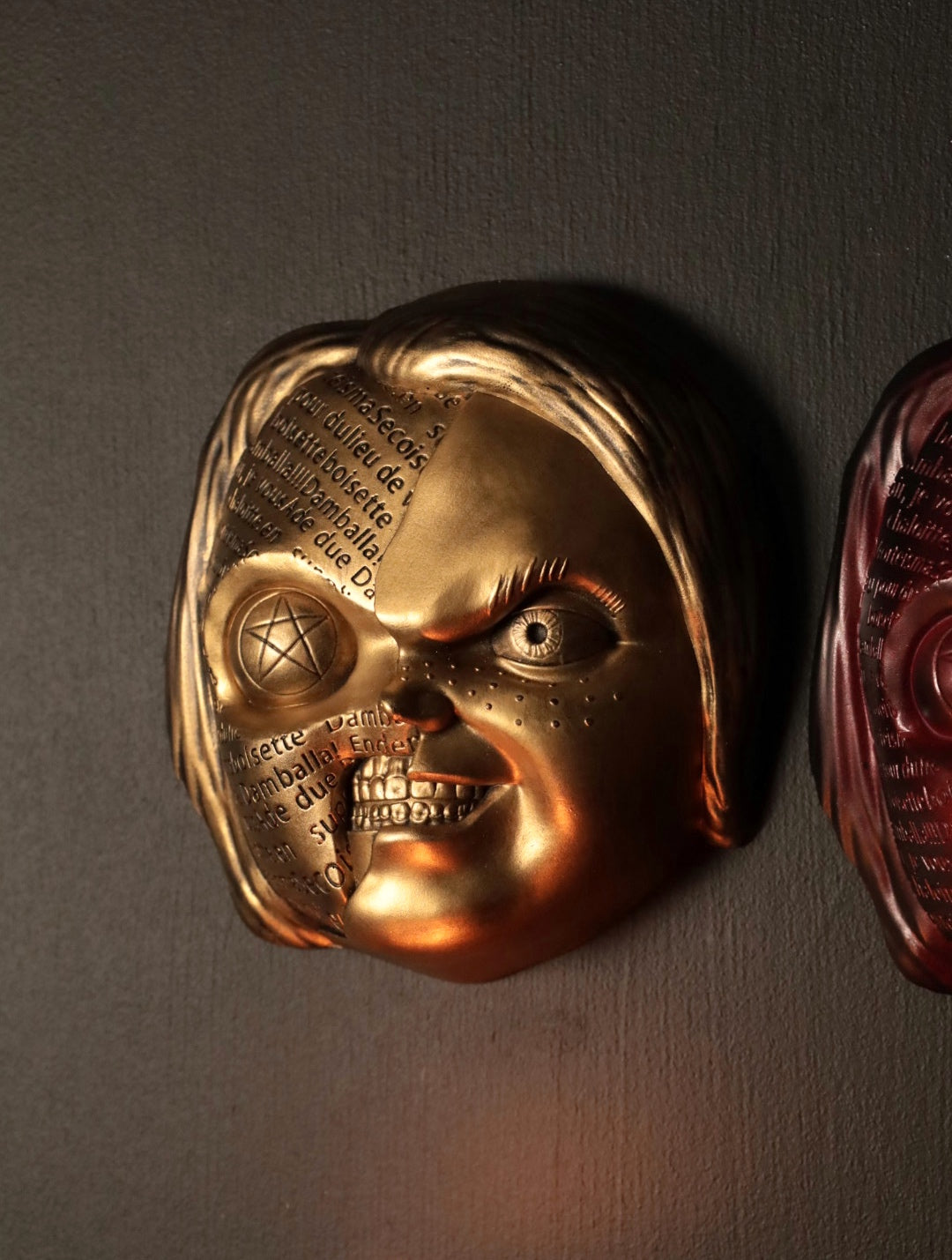 Close up of Chucky wall hanging from the movie Childs Play with the spell. 
