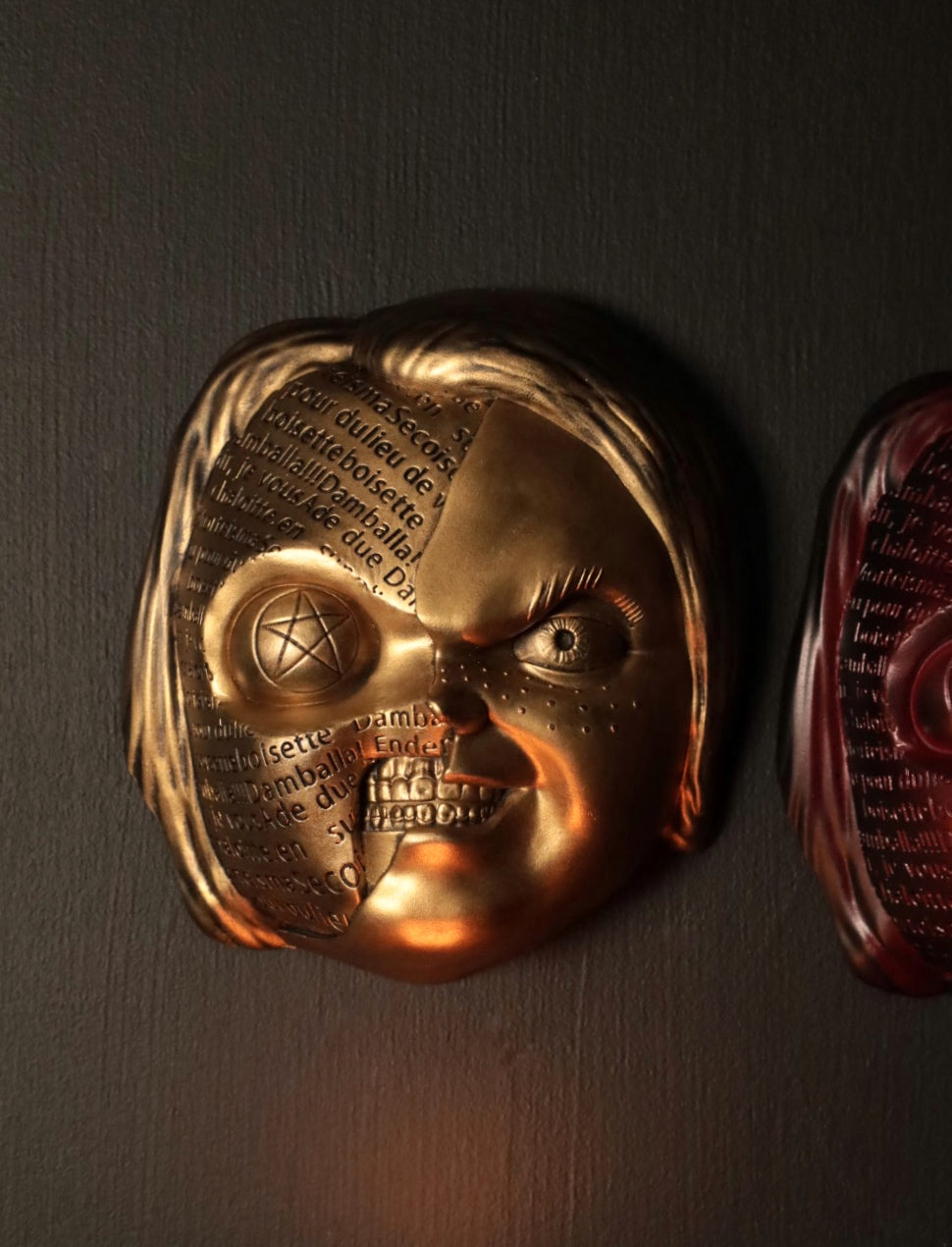 Close up of Chucky wall hanging from the movie Childs Play with the spell. 