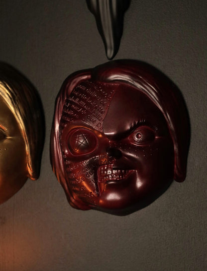 Close up of Chucky wall hanging from the movie Childs Play with the spell. 