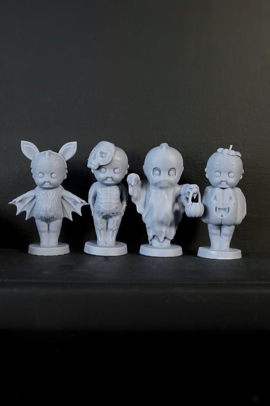 A set of four Kreepy gothic ornaments including designs that resemble a bat, pumpkin, ghost, and skeleton. 