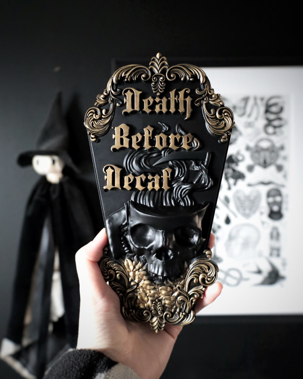 Decorative wall hanging with 'Death Before Decaf' text and skull design