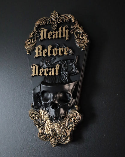 Decorative wall plaque with skull design and 'Death Before Decaf' text on a dark background