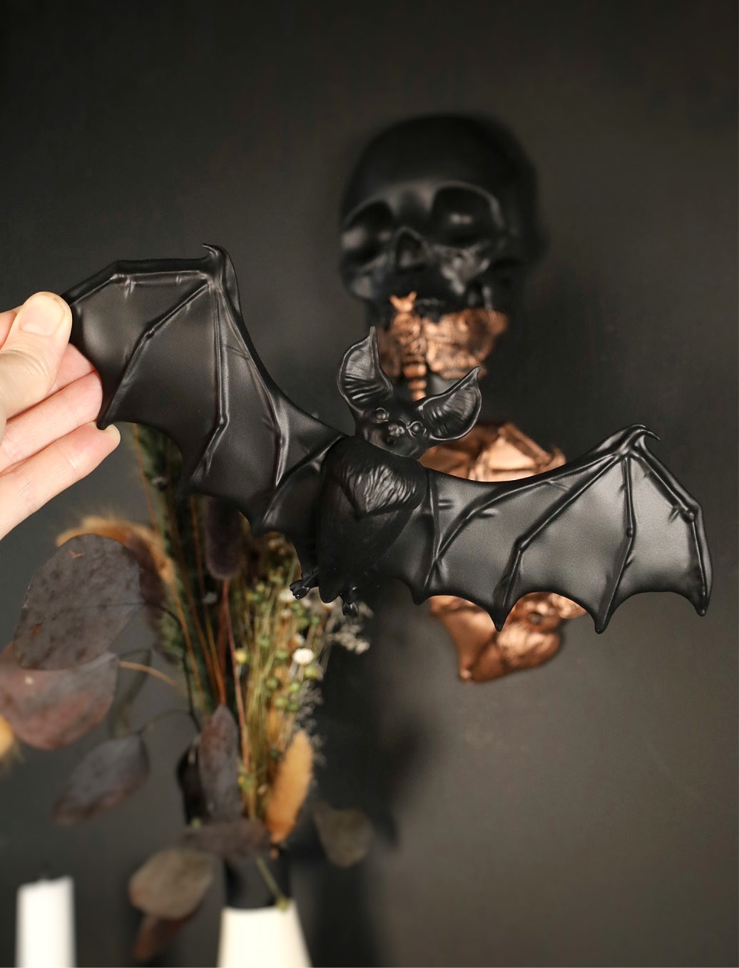 Decorative wall hanging of a flying bat on a dark background