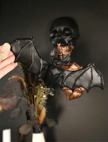 Decorative wall hanging of a flying bat on a dark background