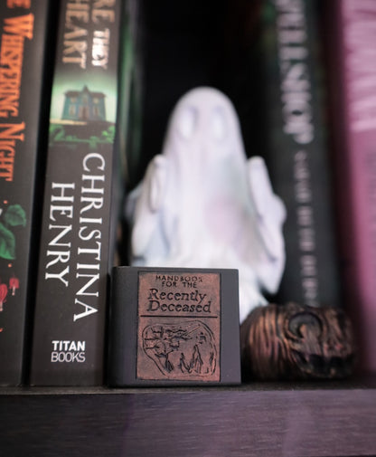 Ghost bookend reading handbook for the recently deceased from the film Beetlejuice. 