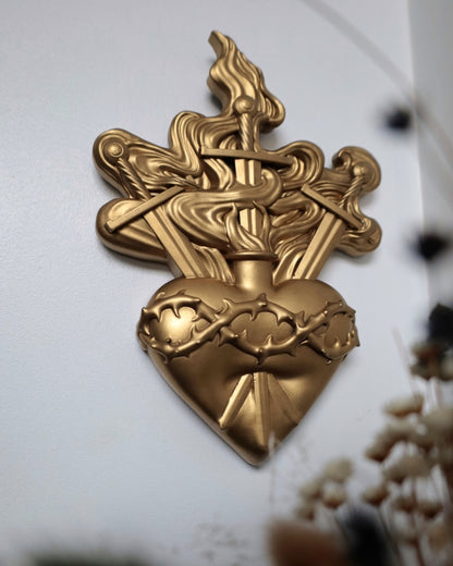 Gold wall decor heart with swords and flames design 