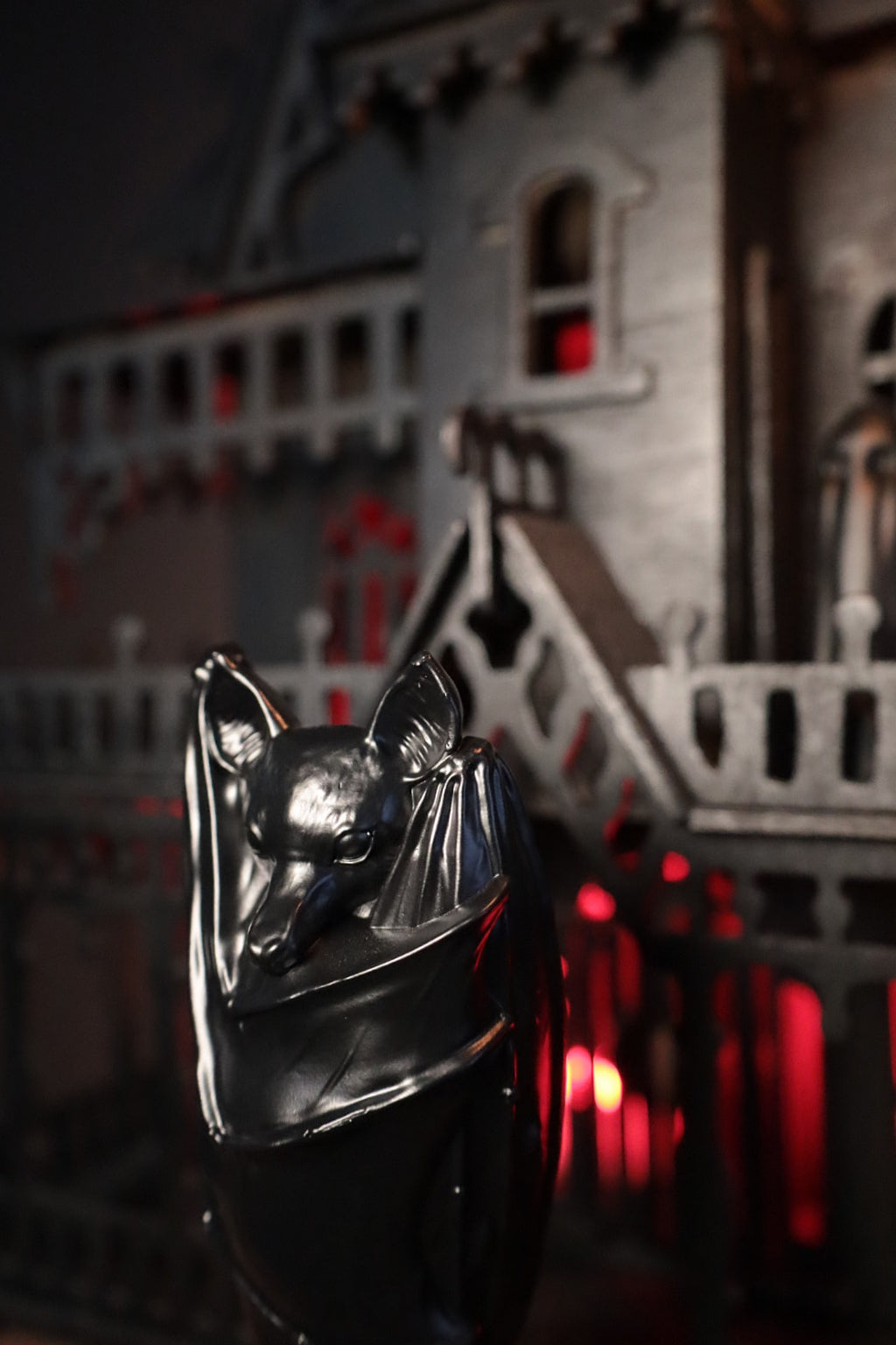 A gothic home decoration piece featuring a gothic black bat on a candle holder