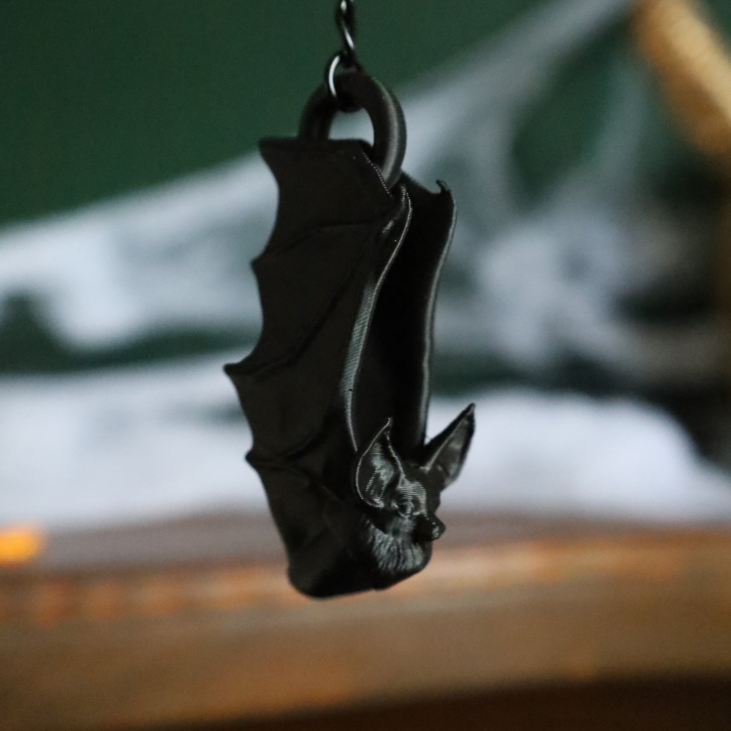 A gothic black bat keyring or cute bag charm hanging from a chain to add a little whimsigoth to your keychain
