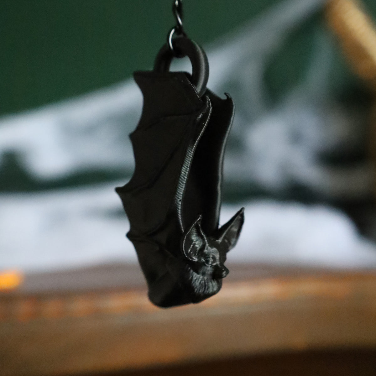 A gothic black bat keyring or cute bag charm hanging from a chain to add a little whimsigoth to your keychain