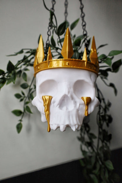 A skull planter with crown and tears made for a gothic home.
