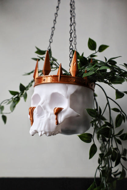 A skull planter with crown and tears made for a gothic home.