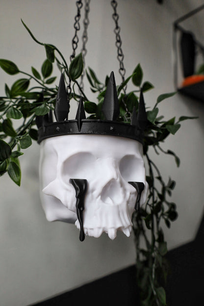 A skull planter with crown and tears made for a gothic home.