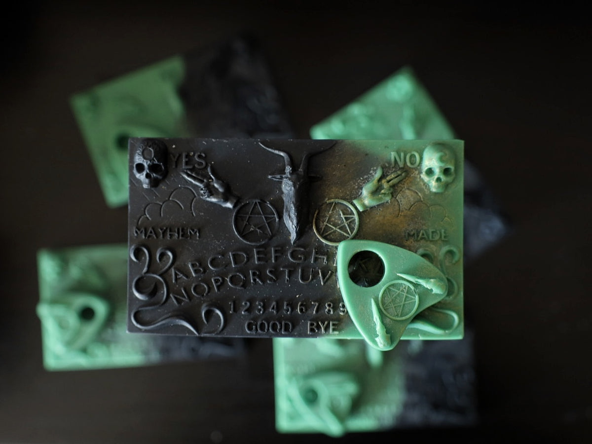 A Ouija board shape wax melt with skull decor. Perfect gifts for goths.