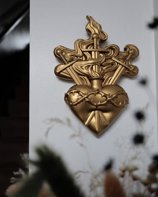 Gold heart with swords and flames design 