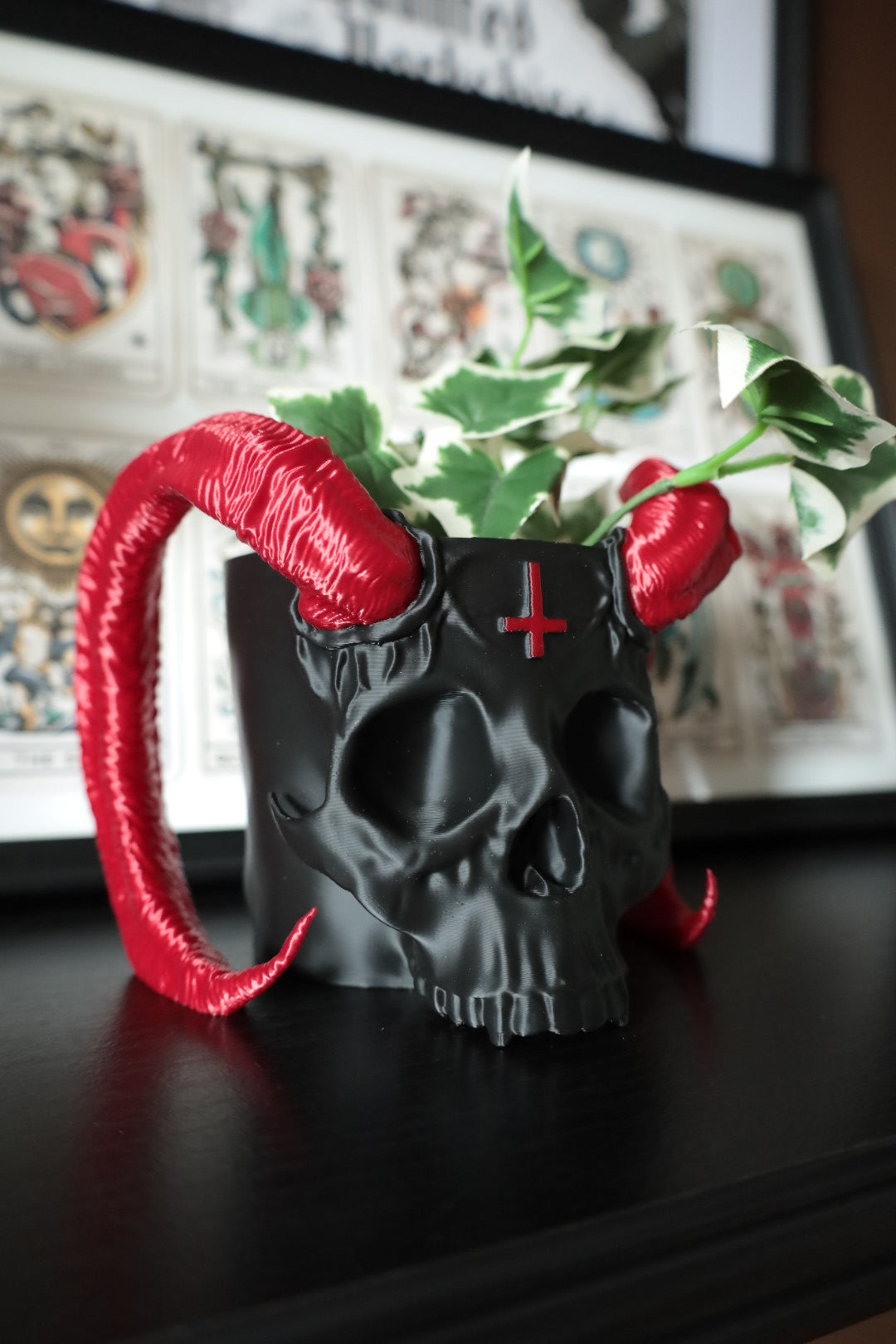 Red and black satan skull planter with inverted cross detailing. Gothic home decor.