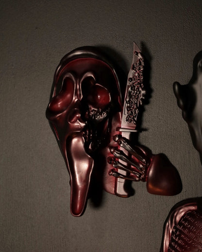 Scream Ghostface mask with a knife and hand holding it against a dark background