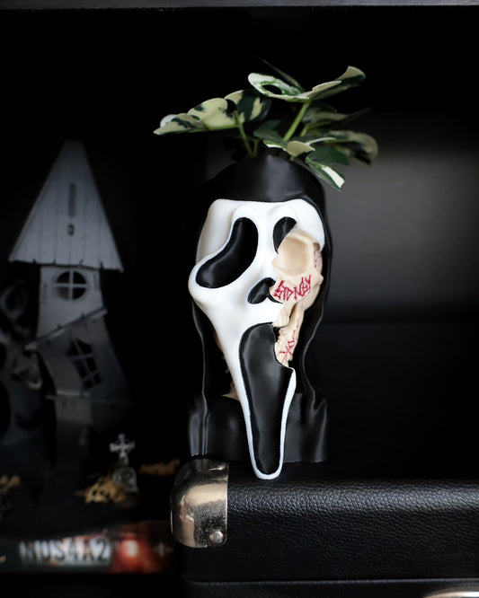 Ghostface from scream desk planter on a shelf 