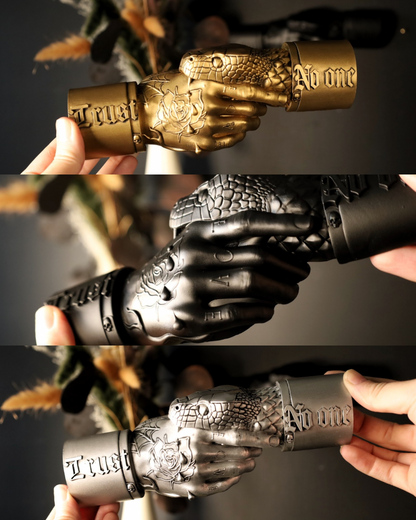 Three views of a tattooed hand wall hanging with a snake biting and the text trust no one. 