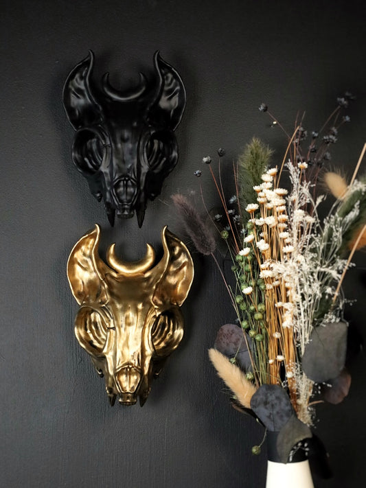 Black and gold cat skull wall decorations with celestial moon detail on gothic gallery wall 