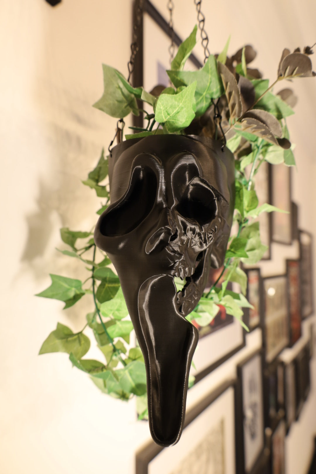 Ghostface from scream black hanging planter with green plants 