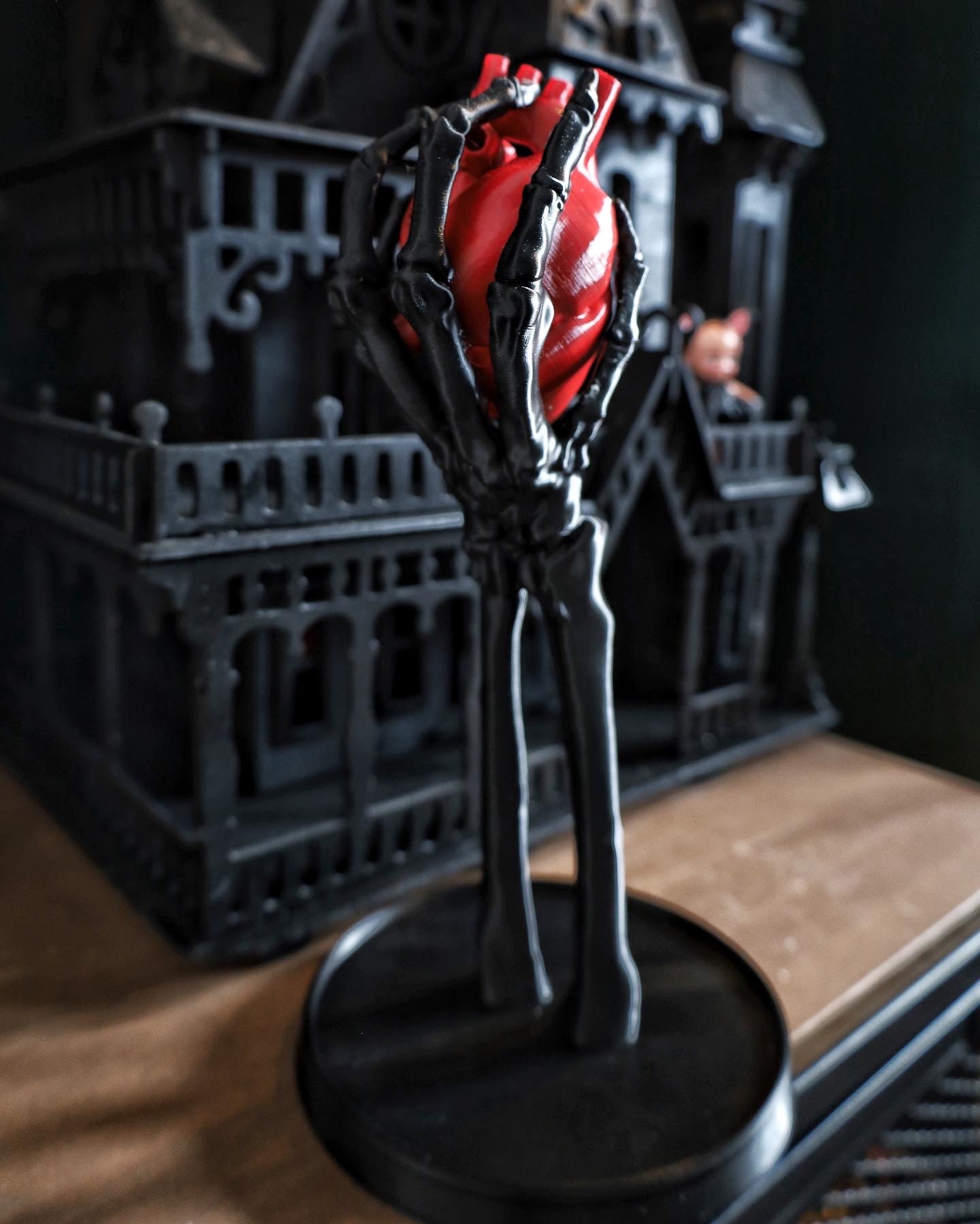 A skeleton hand jewellery stand/ornament holding an anatomical heart, gothic home decor