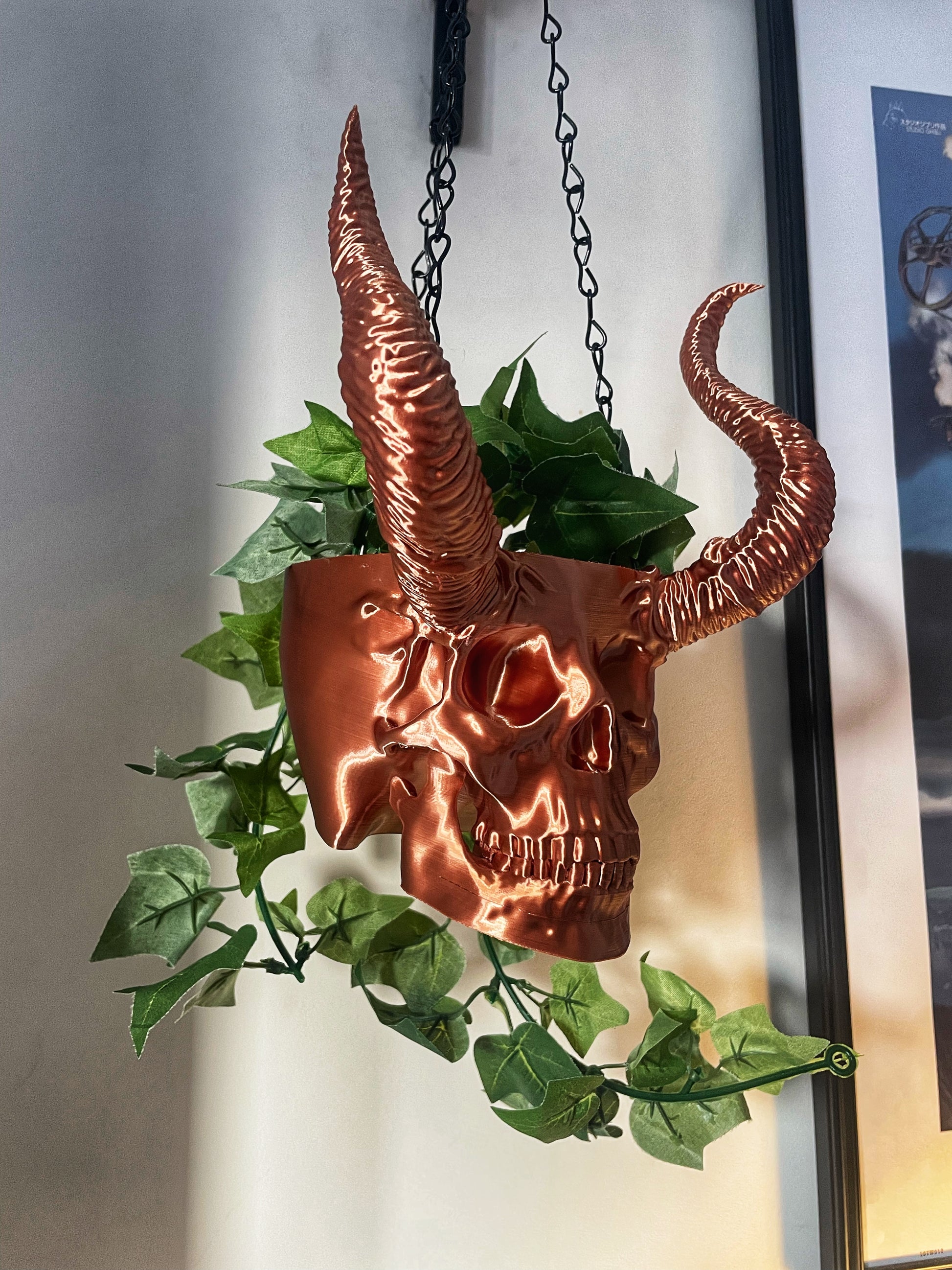 Skull with horned planter with green plants coming out of it 