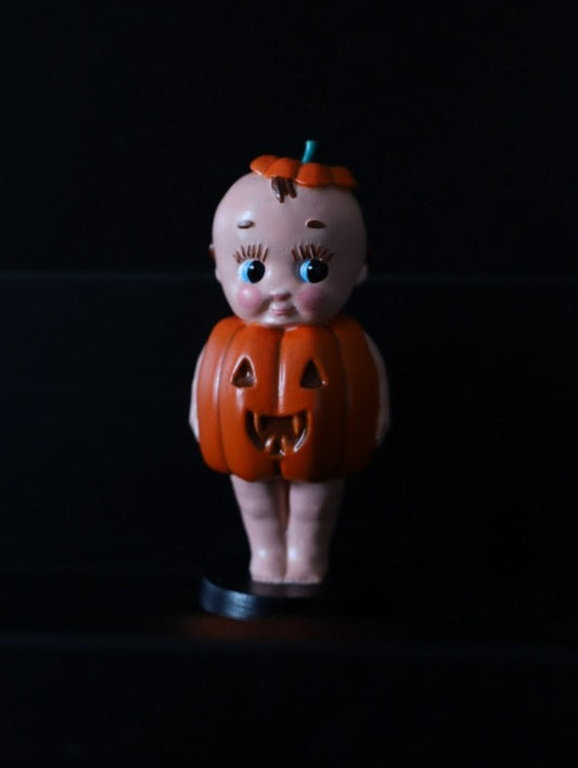 A decorative creepy ornament in a pumpkin design. Creepy cute Halloween decoration